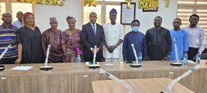 Group photograph of Management and Staff of the Council for the Regulation of Nigeria (CRFFN) and First Mediacon Network Limited during a courtesy visit at the Council's Headquarters in Lagos.